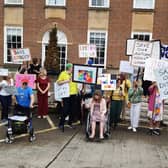 People with autism and other disabilities gathered outside County Hall, Chichester, to protest the decision to remove £250,000 of annual funding from the disability advocacy charity Impact Initiatives which helps more than 450 vulnerable people a year. Picture: Karen Dunn/Sussex World