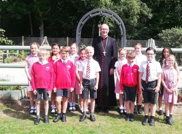 The Bishop of Lewes, the Rt Rev Will Hazlewood, with pupils by the new Peace Garden at Arundel Church of England Primary School