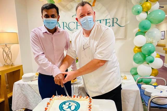 Barchester Healthcare, 30 years of caring, marking the occasion with new General Manager, Devendra and Head Chef, David, cutting the cake 