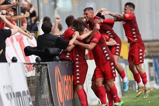 Worthing's players and fans celebrate Lewis White's late winner at St Albans | Picture: Mike Gunn