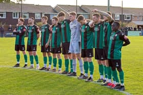 Burgess Hill Town players observer a minute's silence before Saturday's 5-3 defeat to Chichester City. Picture: Chris Neal