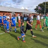 Broadbridge Heath players come out with their mascots to face Erith and Belvedere