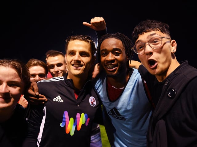 James Balagizi of Crawley Town celebrates with fans following their side's victory in the Carabao Cup Second Round match between Crawley Town and Fulham at Broadfield Stadium on August 23, 2022 in Crawley, England. (Photo by Mike Hewitt/Getty Images)