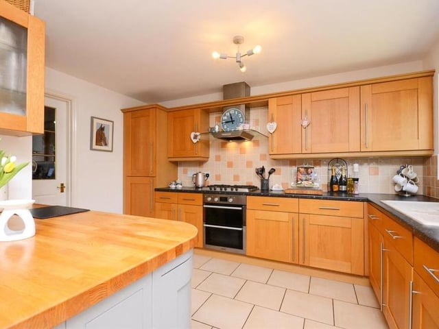 The first room we look at is this attractive kitchen. A brilliant space, slick and clean, with lots of storage units and all the appliances you need.