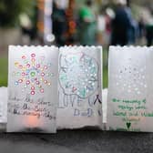 Youngsters lay a lantern to remember a loved one
