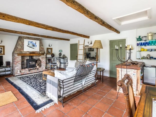 The sitting room has an inglenook fireplace and woodburning stove