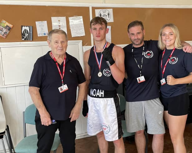 Noah Jolly with coaches John and Danny Essex and Libby Baker  | Picture by Horsham Boxing Club