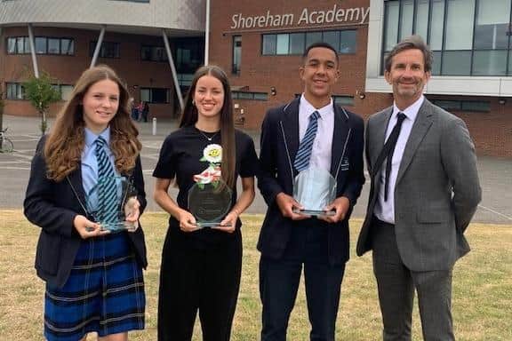 Shoreham Academy principal Jim Coupe with, from left, Grace Nott, Emily Austin and Zack Henry