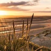 Located in East Sussex, Camber Sands is known for its vast expanse of golden sand dunes and picturesque views. It offers a great spot for swimming, sunbathing, and various water sports