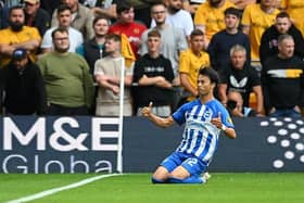 Kaoru Mitoma of Brighton & Hove Albion celebrates after scoring the team's first goal  during the Premier League match at Wolves