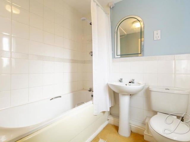 The family bathroom, which is on the first floor, comes complete with a panelled bath, full-height tiling, pedestal sink, low-flush WC and an opaque window to the back of the house.