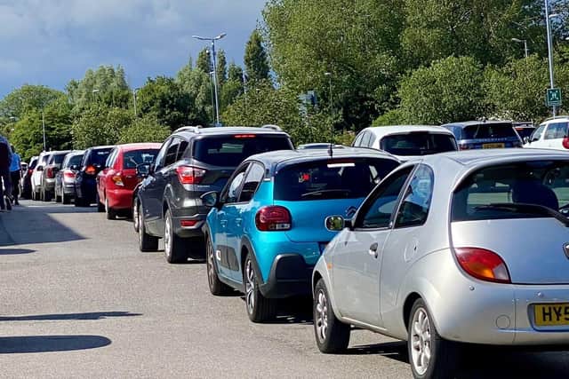 Cars queuing to leave the car park yesterday