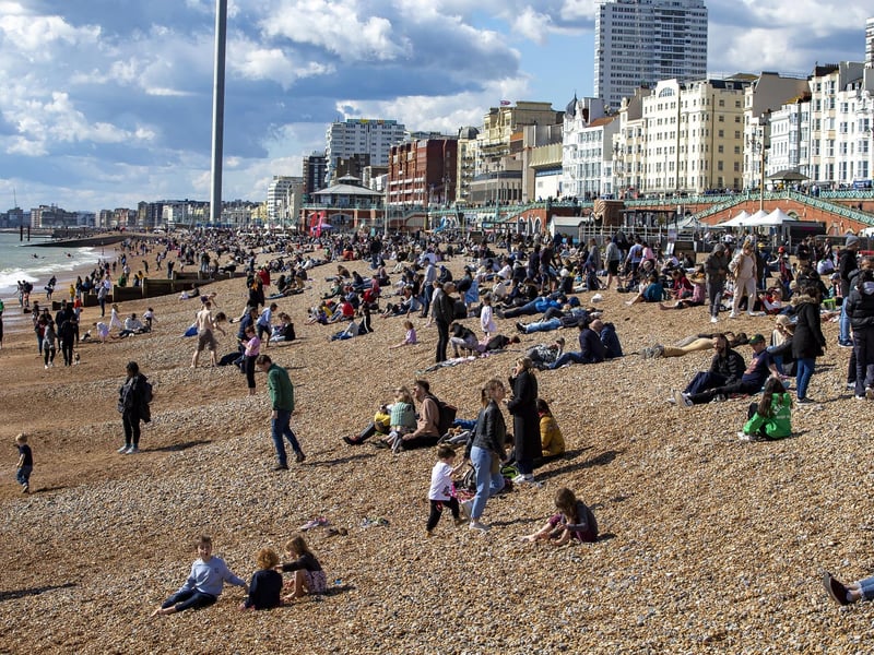 People enjoy the spring sunshine this Good Friday on Brighton beach in East Sussex.