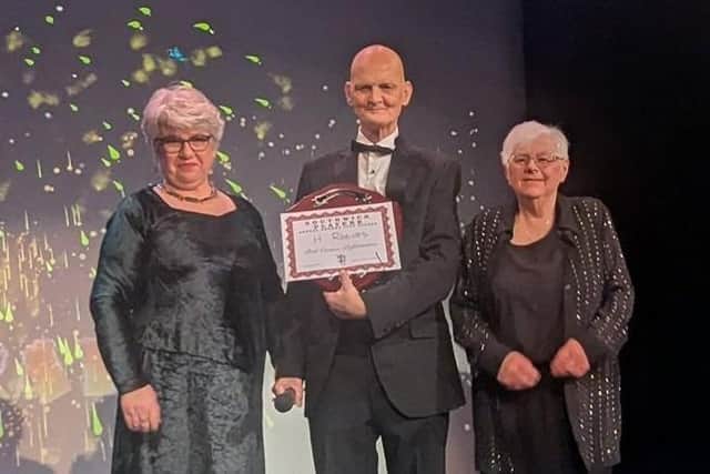 Judges Suse Crosby, left, and Sue Gullen present H Reeves with the award for best cameo performance