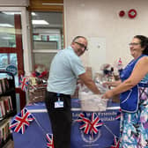 Rosalind Phipps, Chair of The League of Friends, with Miguel Da Silva, Receptionist at Crawley Hospital, drawing the lucky numbers