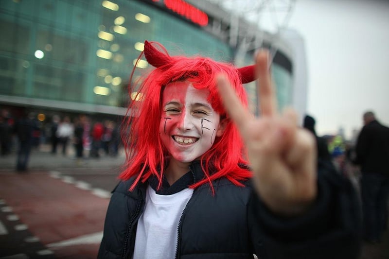 Crawley Town fan Gianluca Magno, aged 11,  enjoys the atmosphere outside Old Trafford as their team prepare to take on Manchester United in the FA Cup fifth round on February 19, 2011.