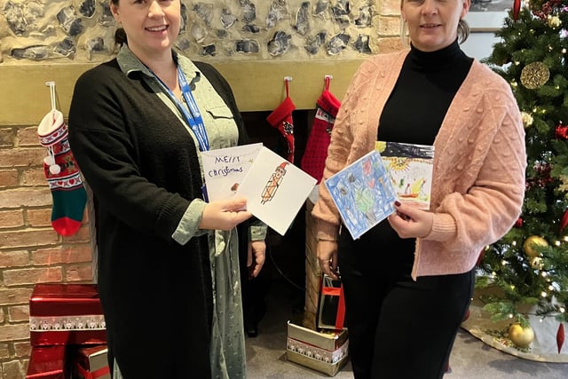 Rachel Tout Head of Marketing from St Wilfirds recieving cards from Lisa Kail of Home Instead