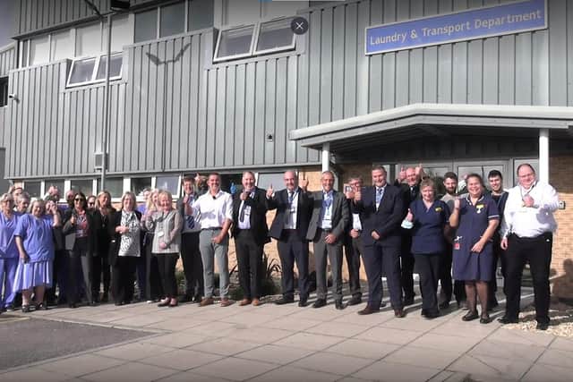 Members of the executive team join staff from the laundry, facilities and estates and capital development to celebrate the official opening of the service at St Richard’s Hospital in Chichester