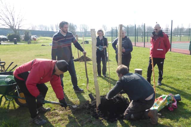 Eastbrook Community Gardeners planting trees at Southwick Community Orchard in March 2022
