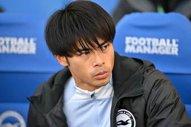 Brighton's Japanese midfielder Kaoru Mitoma looks on from the bench ahead of the English Premier League football match against Tottenham