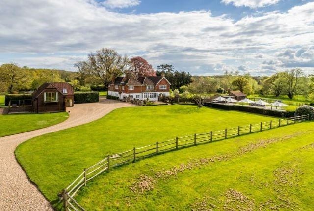 The six-bedroom family home is approached via a sweeping driveway