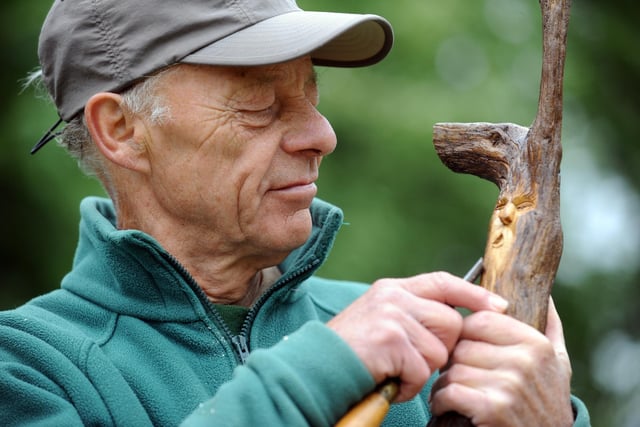 Bodger Richard Eade whittles a spirit of the woods at his 'all things wood' stall