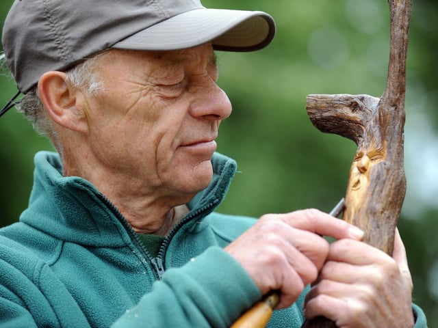 Bodger Richard Eade whittles a spirit of the woods at his 'all things wood' stall