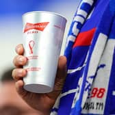 A fan takes a drink from a Budweiser Zero cup prior to the FIFA World Cup Qatar 2022 Group D match between France and Australia at Al Janoub Stadium