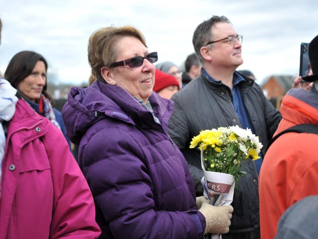 An attendee of the march with flowers in hand. Pic S RobardsSR2303061