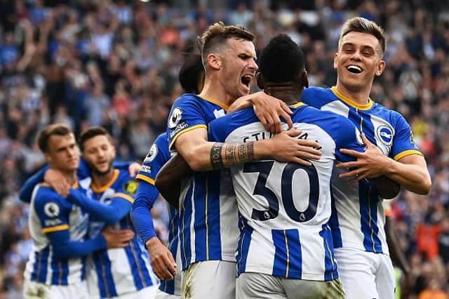 Brighton's Ecuadrorian defender Pervis Estupinan celebrates with teammates after Chelsea's defender Trevoh Chalobah scored an own goal and Brighton's third in the Premier League at the Amex Stadium