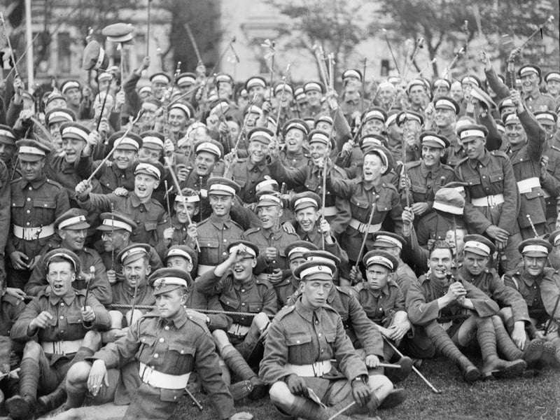 Cheering spectators waving batons at an RAF Sports meeting held at Hastings.