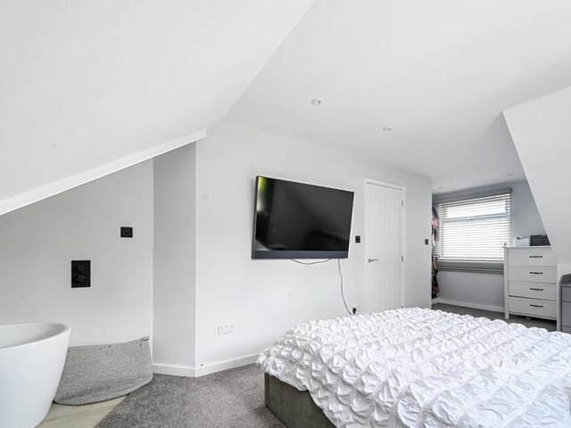The master bedroom features a dressing area and roll-top bath