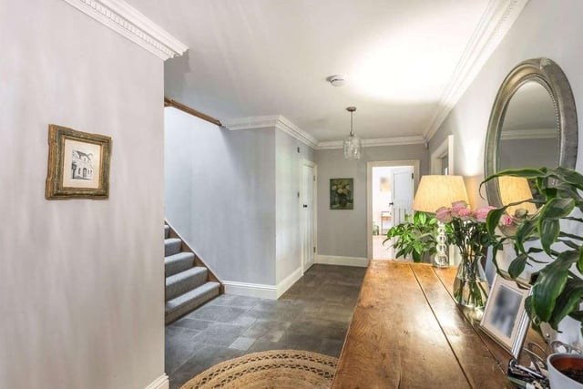 There is a spacious entrance hall with adjacent boot room with limestone flooring