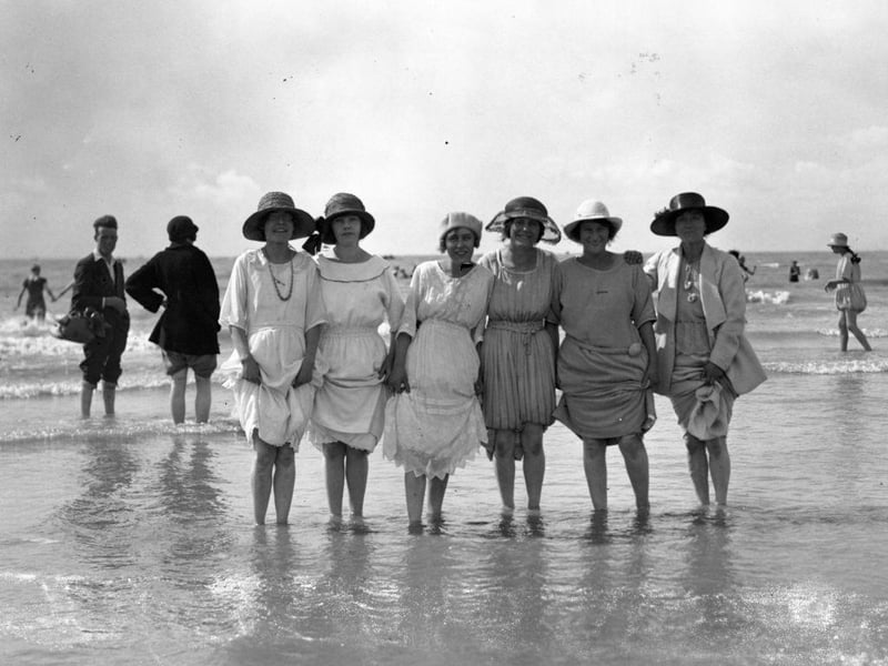 A group of workers from Tickler's Jam Factory paddling in the sea during an outing to Hastings.