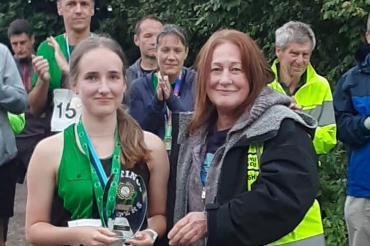 Rowan Barton-Dibble receives her Hastings 5 mile race junior girls award from Jo Edwards