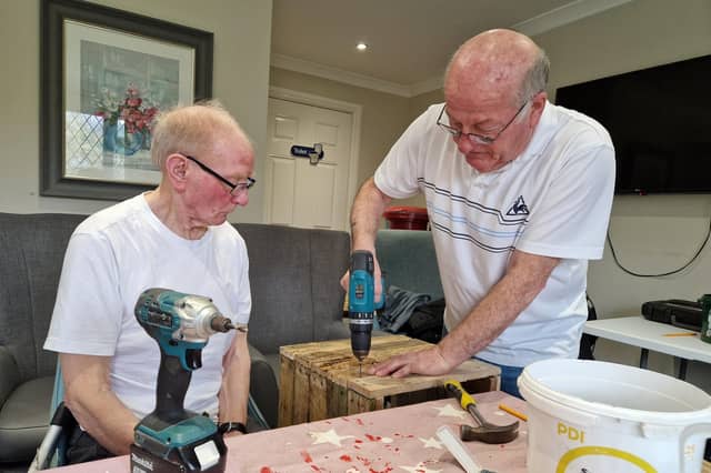 Jim Cox, left, working with Jim Dumbrell on a tortoise house