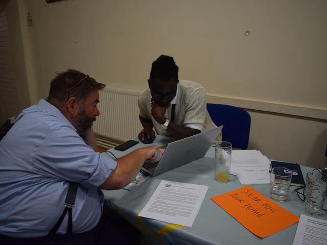 Churchill Utomi, ESC technical manager, showing a resident the solar map