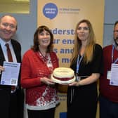 Councillor Michael Jones with Councillor Sue Mullins, who baked and presented a celebration cake to Emma Cross (CEO CAWS) and Jason Mather (Head of Client Services, CAWS) (Photo by Jon Rigby)