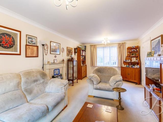 A second shot of the living room, which shows how large, bright and airy it is, making it the ideal spot for entertaining guests. A window overlooks the front of the property, while the floor is carpeted.