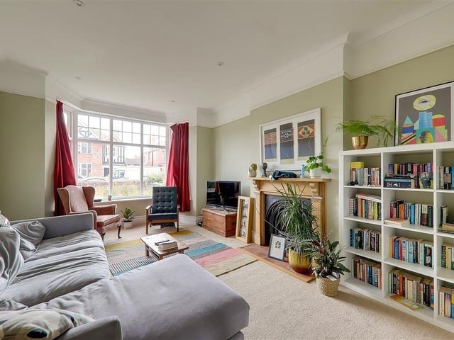 The living room has a feature older-style fireplace and surround