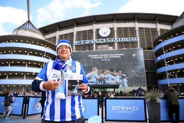 A Brighton and Hove Albion fan holds up a matchday programme ahead of the Premier League match between Manchester City and Brighton & Hove Albion at Etihad Stadium on September 29, 2018.