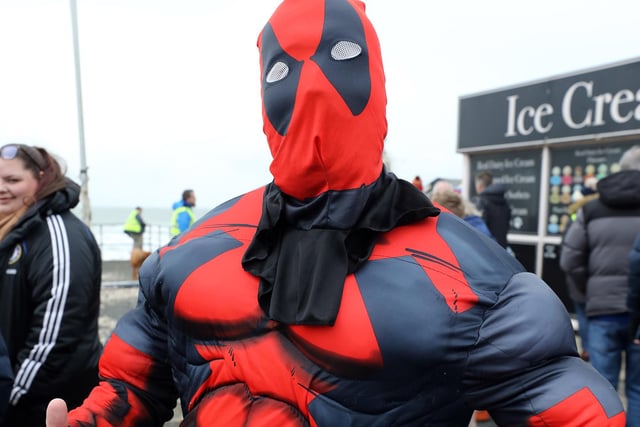 Some 385 people braved the ice cold sea water on New Year's Day 2024. Rob Napper as Deadpool)