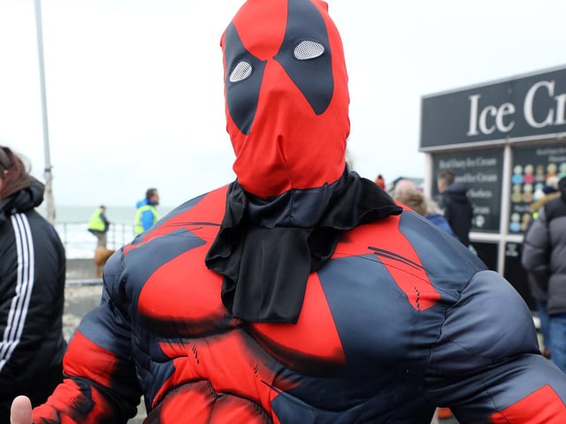 Some 385 people braved the ice cold sea water on New Year's Day 2024. Rob Napper as Deadpool)