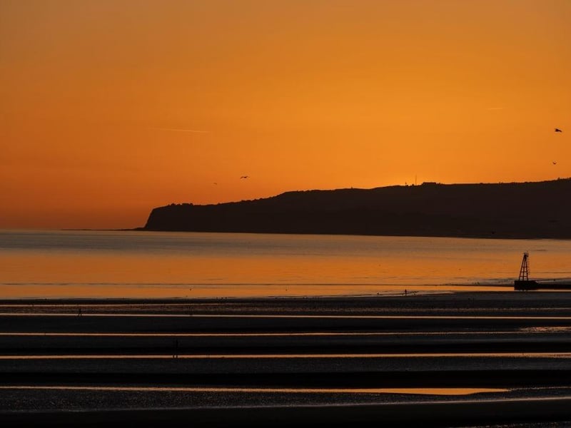 The sun sets over Camber Sands.
