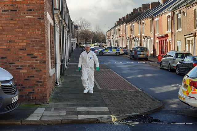 Forensic officers continuing their work at the scene on Sunday.