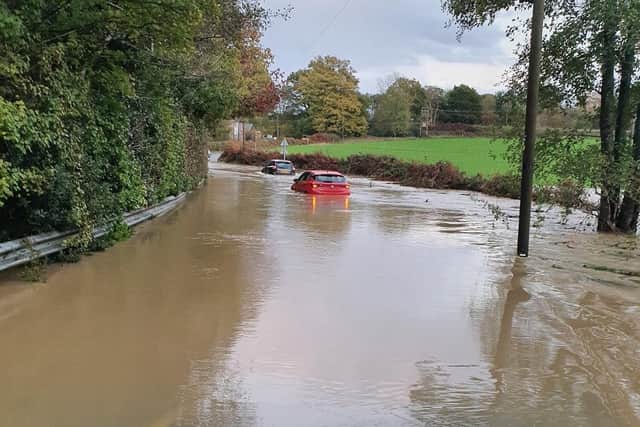 Police officers have been called to Monteswood Lane, where two vehicles are stranded in floodwater. Photo: Mid Sussex Police