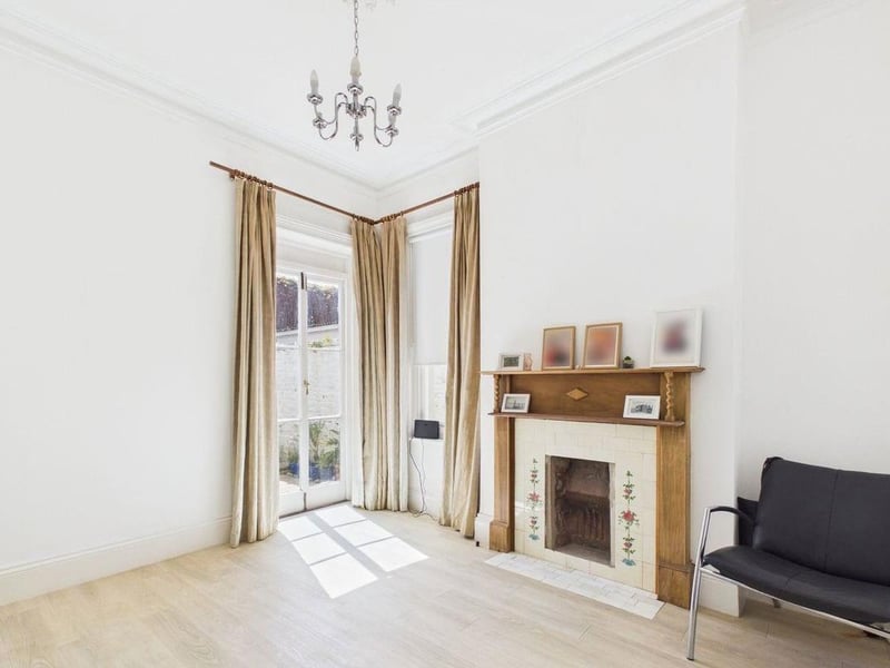 The dining room has a character fireplace and double French doors to the garden