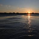 The sun rises over the beach at West Wittering on the south coast of England.