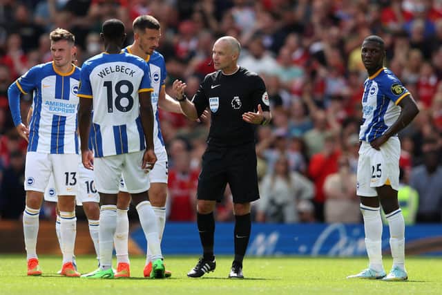Danny Welbeck and Lewis Dunk of Brighton & Hove Albion talk to referee Paul Tierney during the Premier League match between Manchester United and Brighton & Hove Albion (Photo by Catherine Ivill/Getty Images)