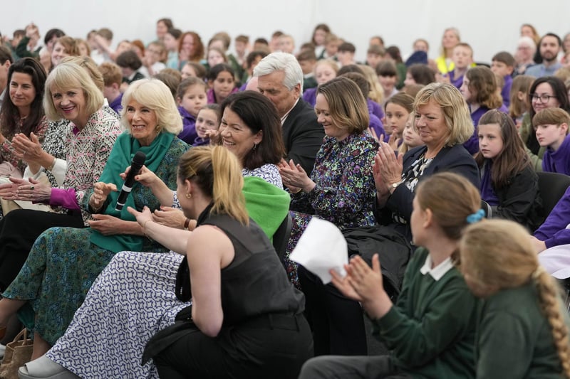 CHARLESTON, UNITED KINGDOM - MAY 16: Britain's Queen Camilla is handed a microphone as she sits in the audience during a surprise appearance at the opening session of the Charleston Festival in Charleston in Firle on May 16, 2024 in Charleston, England. The Queen joins this year's opening event called the 'Power of Reading', aiming to celebrate the power of books and reading for children and young people. (Photo by Kirsty Wigglesworth - WPA Pool/Getty Images)